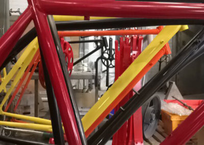 A set of bicycle chassis and other bicycle parts in drying area at Tallaght Powder Coating