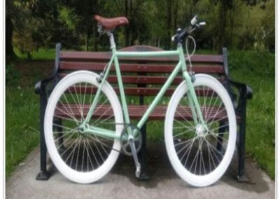 A newly-painted mint green bike with white wheels at the bench by Tallaght Powder Coating Services