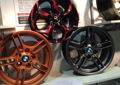 Mitsubishi and BMW alloy mag wheels displayed on a rack