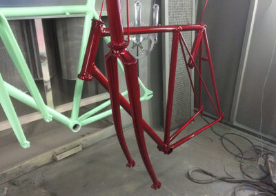 Drying of bicycle chassis and sprocket in mint green, deep red and silver paint color