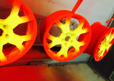 Mag wheels painted in bright yellow and orange by Tallaght Powder Coating Services