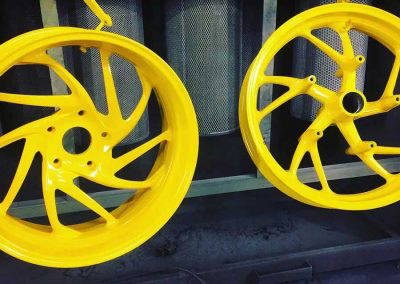 Bright yellow powder coated alloy wheels for motorcycles by Tallaght Powder Coating Dublin