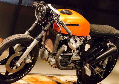 Custom Honda motorcycle with orange tank and black powder coated alloy wheels by Tallaght Powder Coating Dublin