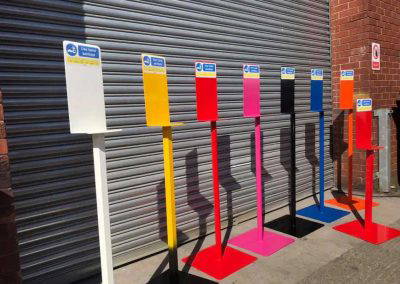 Powder coated hand sanitiser stands in multiple colours outside Tallaght Powder Coating Dublin