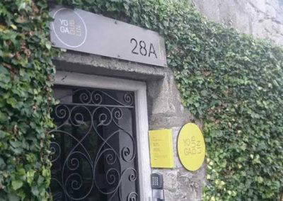 Powder coated metal signage and number plate at 28A entrance with ivy wall